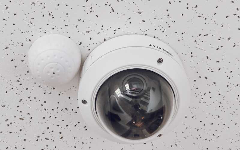 modern security camera and alarm sensor